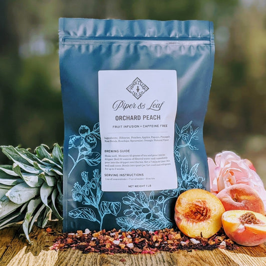 Piper and Leaf Tea Co. Orchard Peach loose tea in a pound bag, showing fresh peach-flavored tea leaves for brewing.