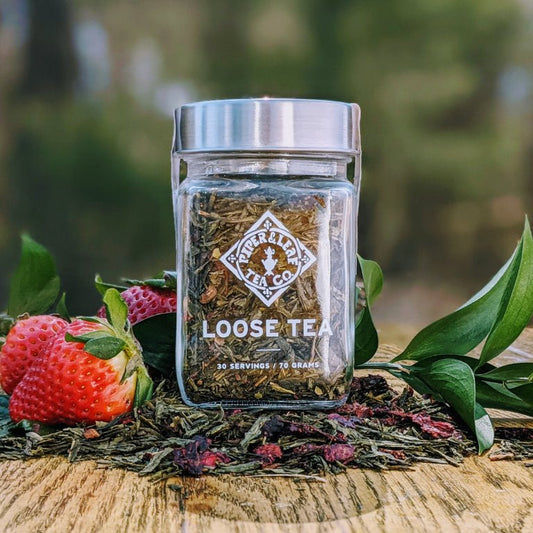 Glass jar of Sassyfras Strawberry loose leaf tea by Piper and Leaf Tea Co. with visible tea leaves inside.
