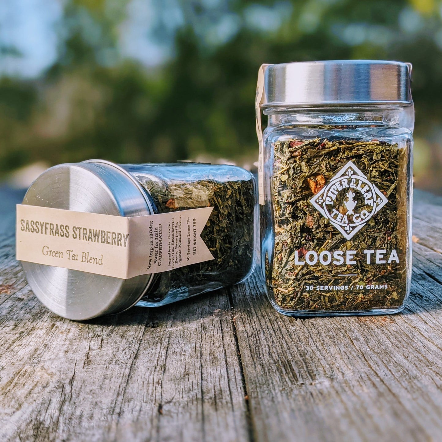 Glass jar of Piper and Leaf Tea Co. Sassyfras Strawberry Loose Leaf Tea, showing fresh tea leaves inside.