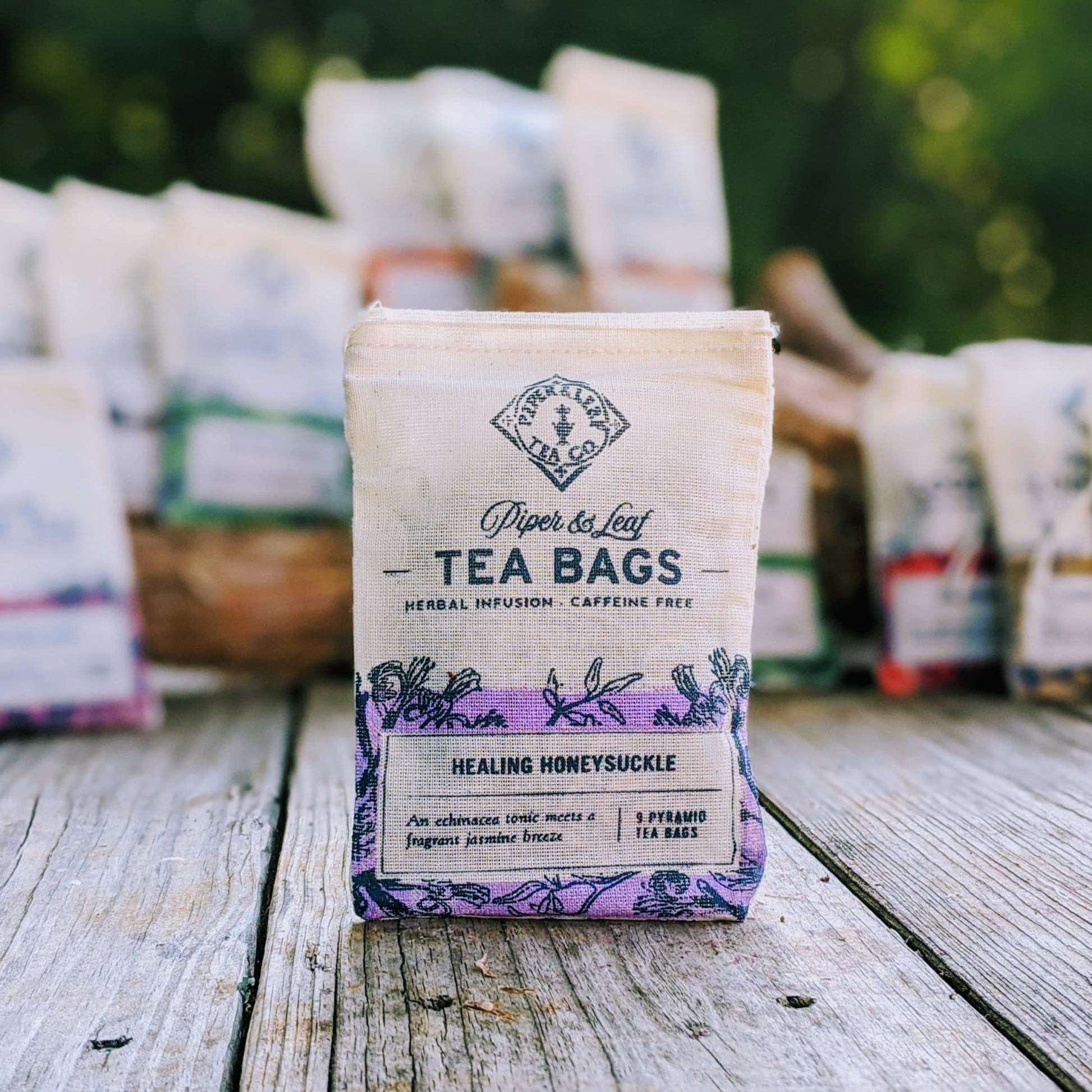 Healing Honeysuckle 9ct tea bags from Piper and Leaf Tea Co. in muslin packaging, showcasing herbal tea bags with fresh honeysuckle flowers.