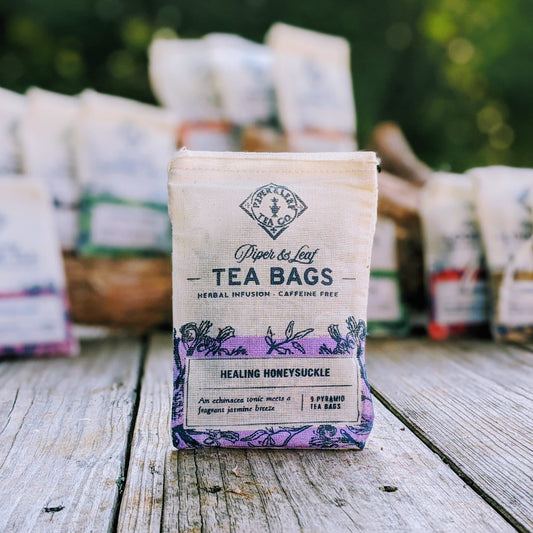 Healing Honeysuckle 9ct tea bags from Piper and Leaf Tea Co. in muslin packaging, showcasing herbal tea bags with fresh honeysuckle flowers.