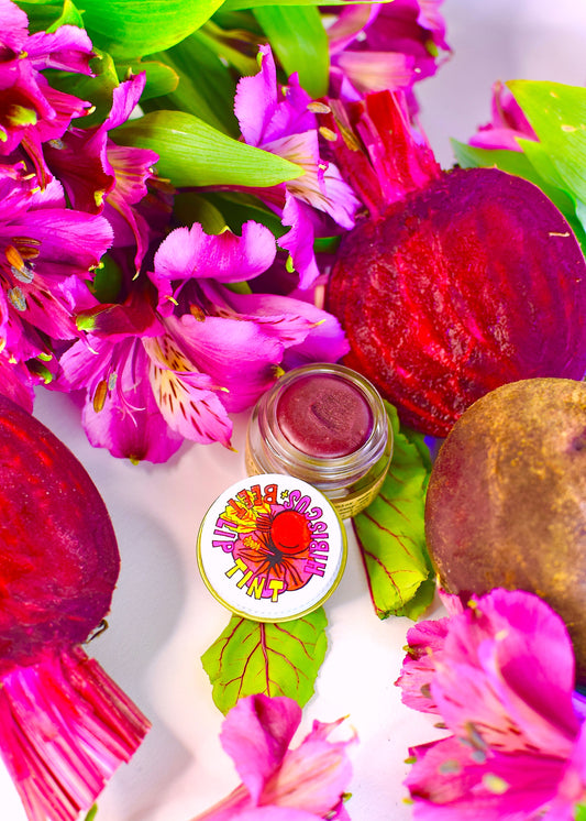 Plant Makeup Hibiscus and Beet Lip Tint in a sleek tube, showcasing its vibrant color and natural ingredients for nourishing lips.