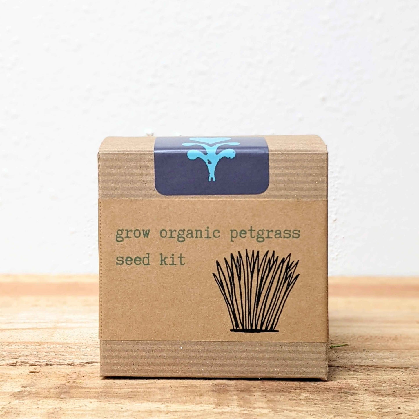 Organic Petgrass Grow Kit with sprouting seeds for healthy pet grass, by Plantflix, displayed with sprouted green grass in the kit.