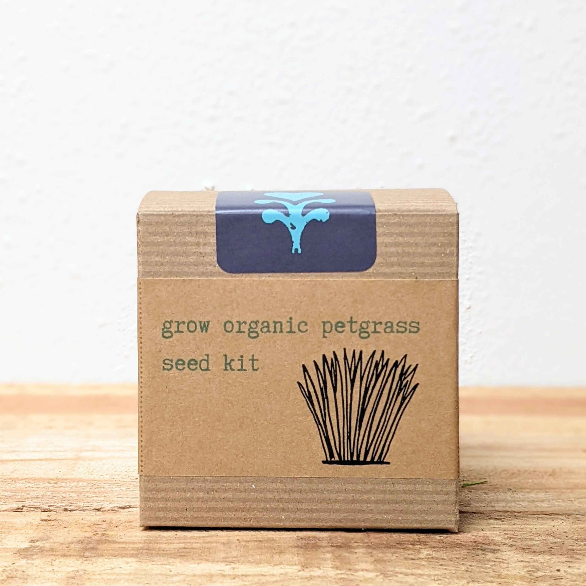 Organic Petgrass Grow Kit with sprouting seeds for healthy pet grass, by Plantflix, displayed with sprouted green grass in the kit.