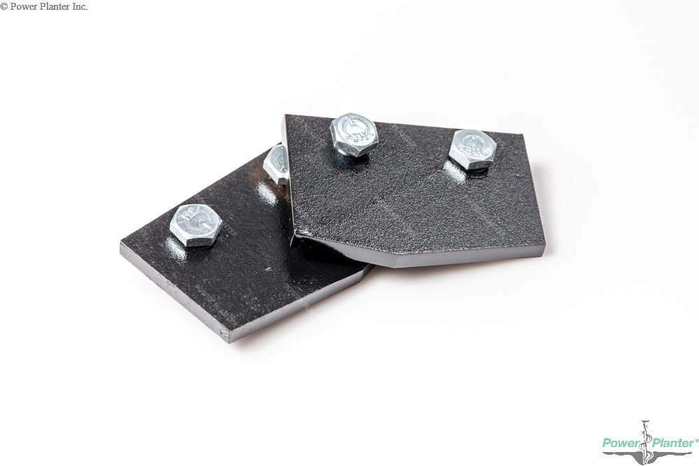 Two black beveled-edge metal plates, each fastened by two silver bolts, are stacked slightly askew on a white background. These Power Planter Augers' Auger Replacement Blades are perfect for updating your post hole digger.