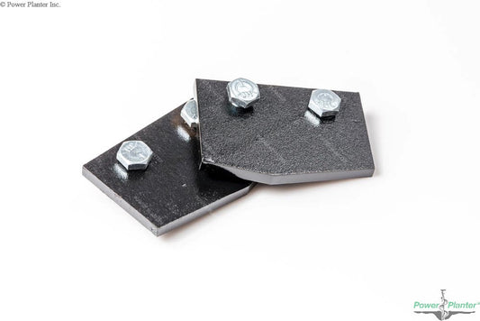 Two black beveled-edge metal plates, each fastened by two silver bolts, are stacked slightly askew on a white background. These Power Planter Augers' Auger Replacement Blades are perfect for updating your post hole digger.
