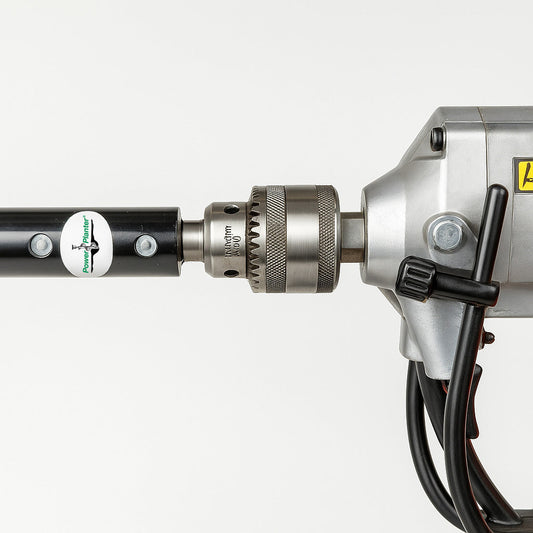 Close-up of a Power Planter Augers Heavy Duty 1/2" Hex Auger Adapter with black shaft, inserted into a drill's chuck. Drill wires and metallic casing are visible against a white background.