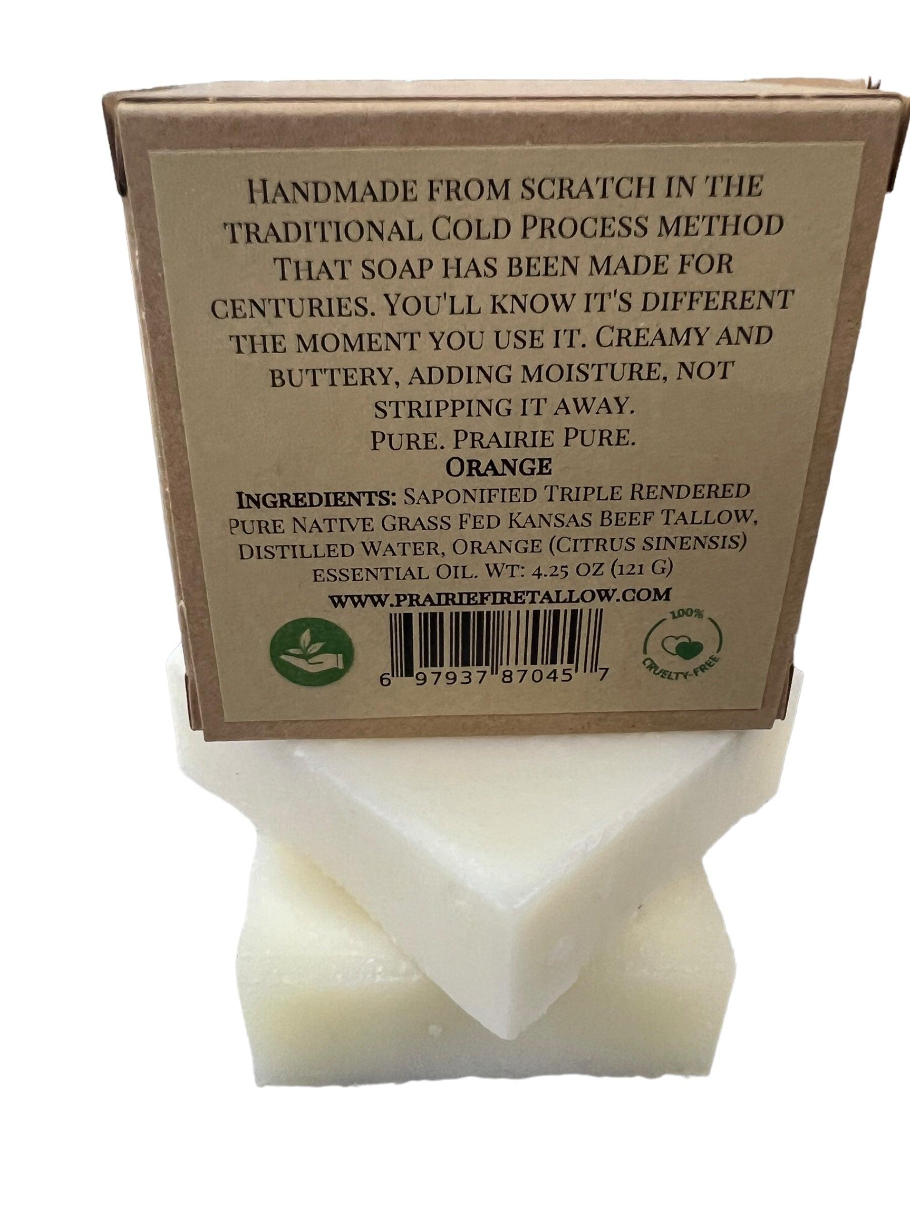 A white-wrapped bar of Prairie Fire Tallow, Candles, and Lavender Pure Beef Tallow Soap (3 Pack); handmade, cold-processed, grass-fed tallow with orange essential oil for creamy lather. Ingredients and website listed.