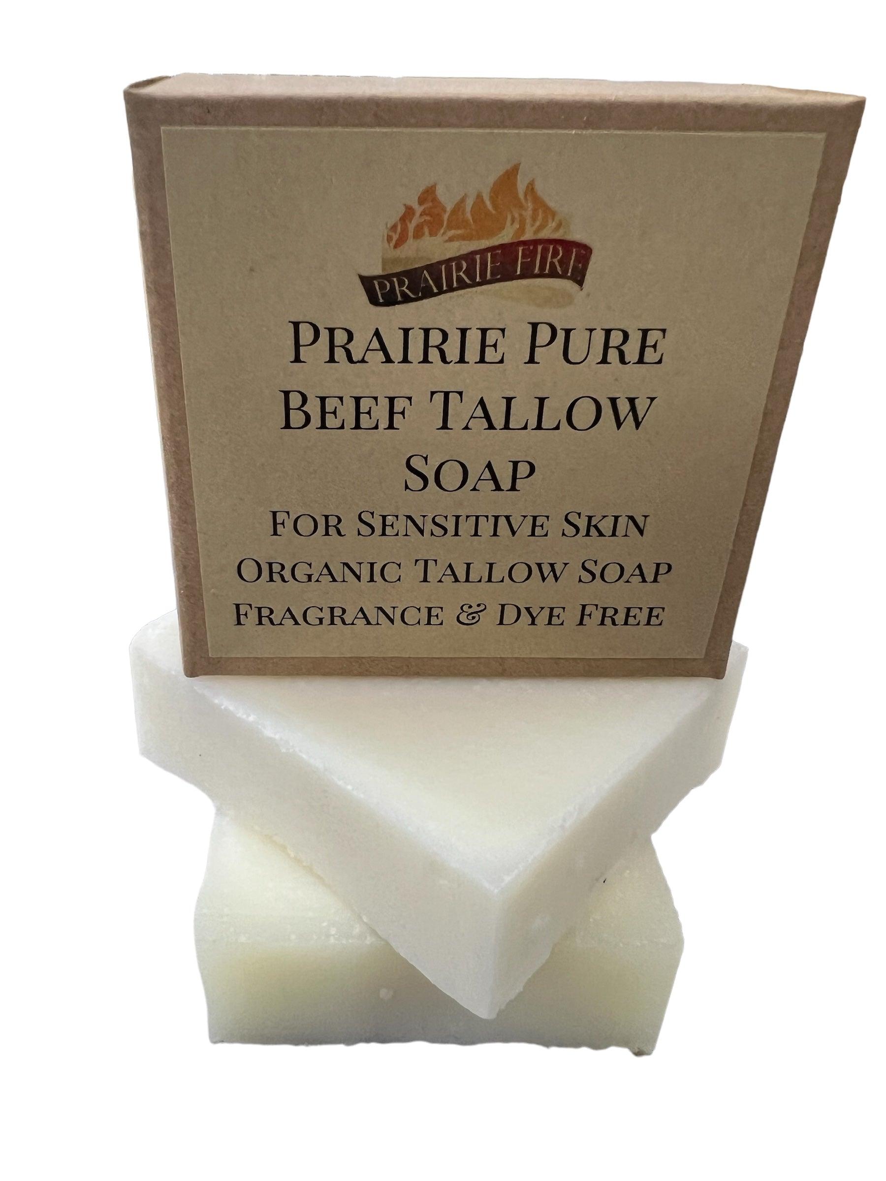 A box labeled Prairie Fire Pure Beef Tallow Soap Bar (3 Pack) sits on two white bars. The label says its natural, organic, grass fed and finished, made in the USA for face, body, and hair—cleanses, moisturizes, soothes and hydrates.