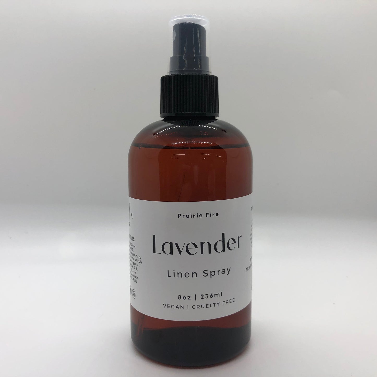 Lavender Linen Spray by Prairie Fire Tallow, Candles, and Lavender, 8oz bottle with a lavender-colored label and floral design.