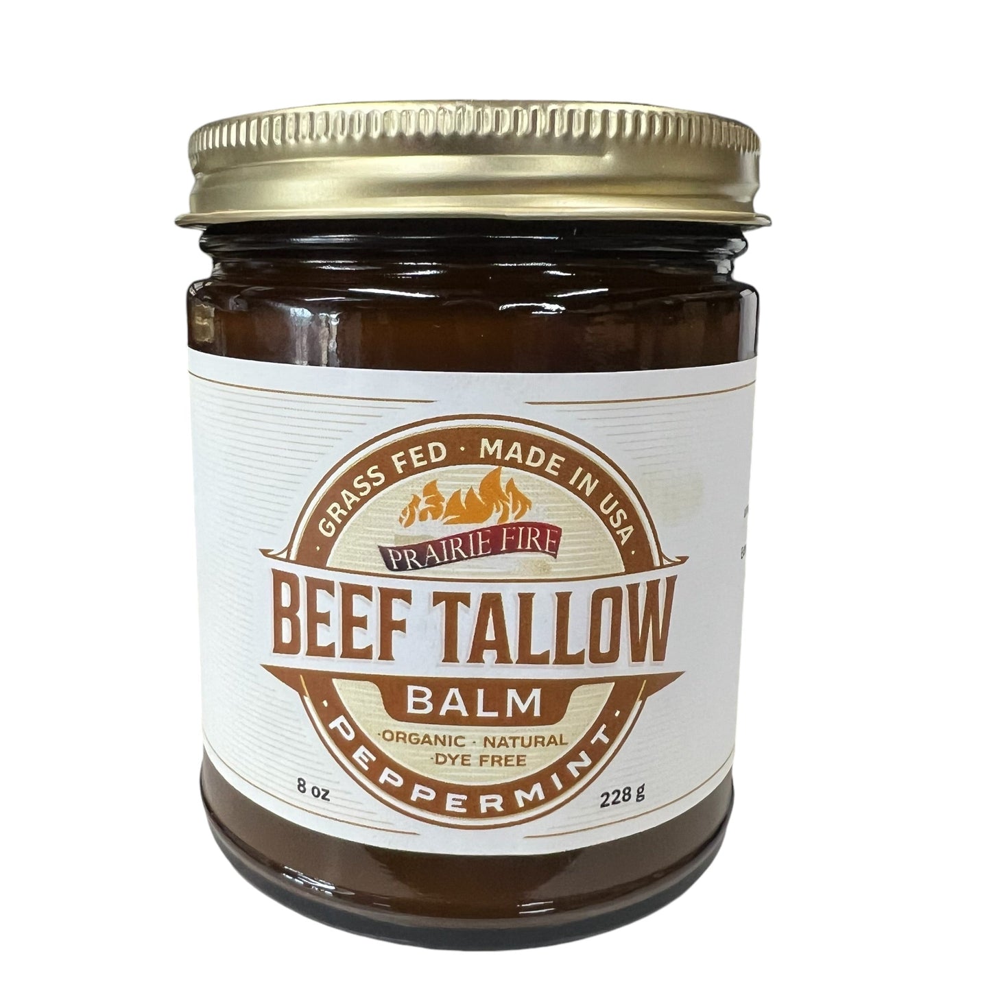 A brown glass jar with gold lid labeled Beef Tallow Balm by Prairie Fire Tallow, Candles, and Lavender; this 8 oz moisturizer is made in the USA from organic grass-fed and finished tallow.