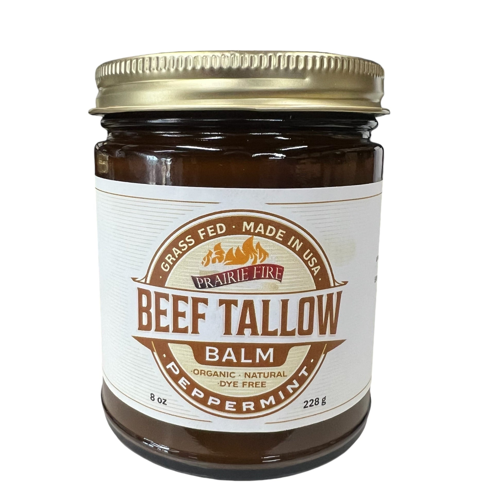 A brown glass jar with gold lid labeled Beef Tallow Balm by Prairie Fire Tallow, Candles, and Lavender; this 8 oz moisturizer is made in the USA from organic grass-fed and finished tallow.