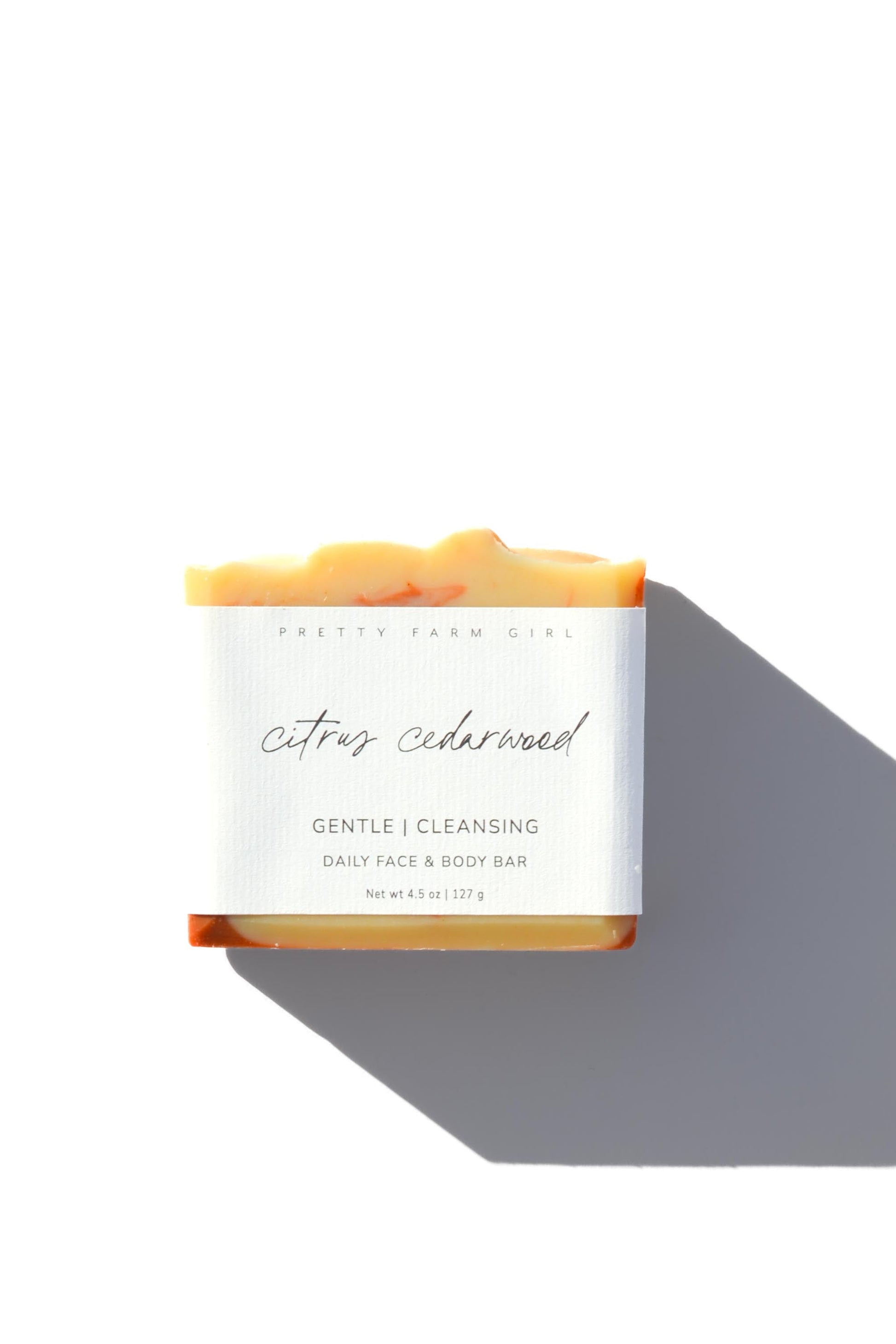 Handmade citrus cedarwood soap bar with tallow and goat milk from Pretty Farm Girl, showing the textured, natural soap surface.