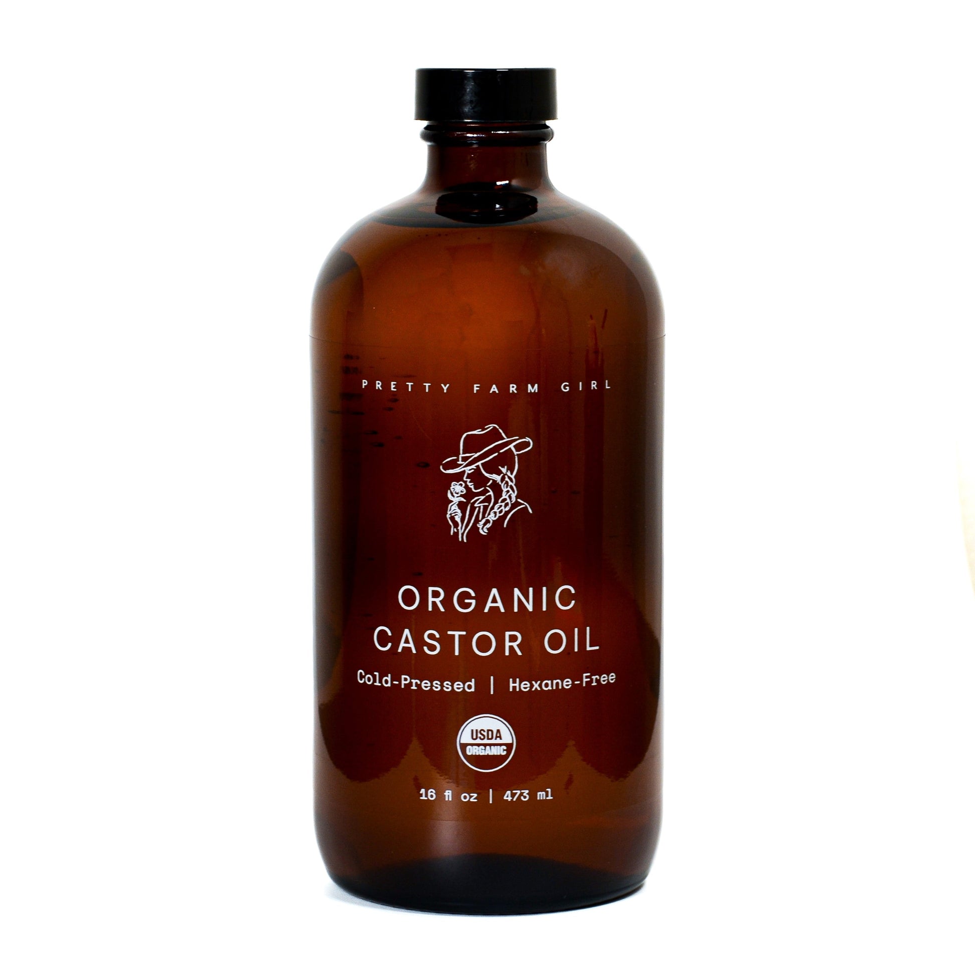 Pure organic cold-pressed castor oil from Pretty Farm Girl, 16 oz bottle, hexane-free essential oil, with a clear label and cap.