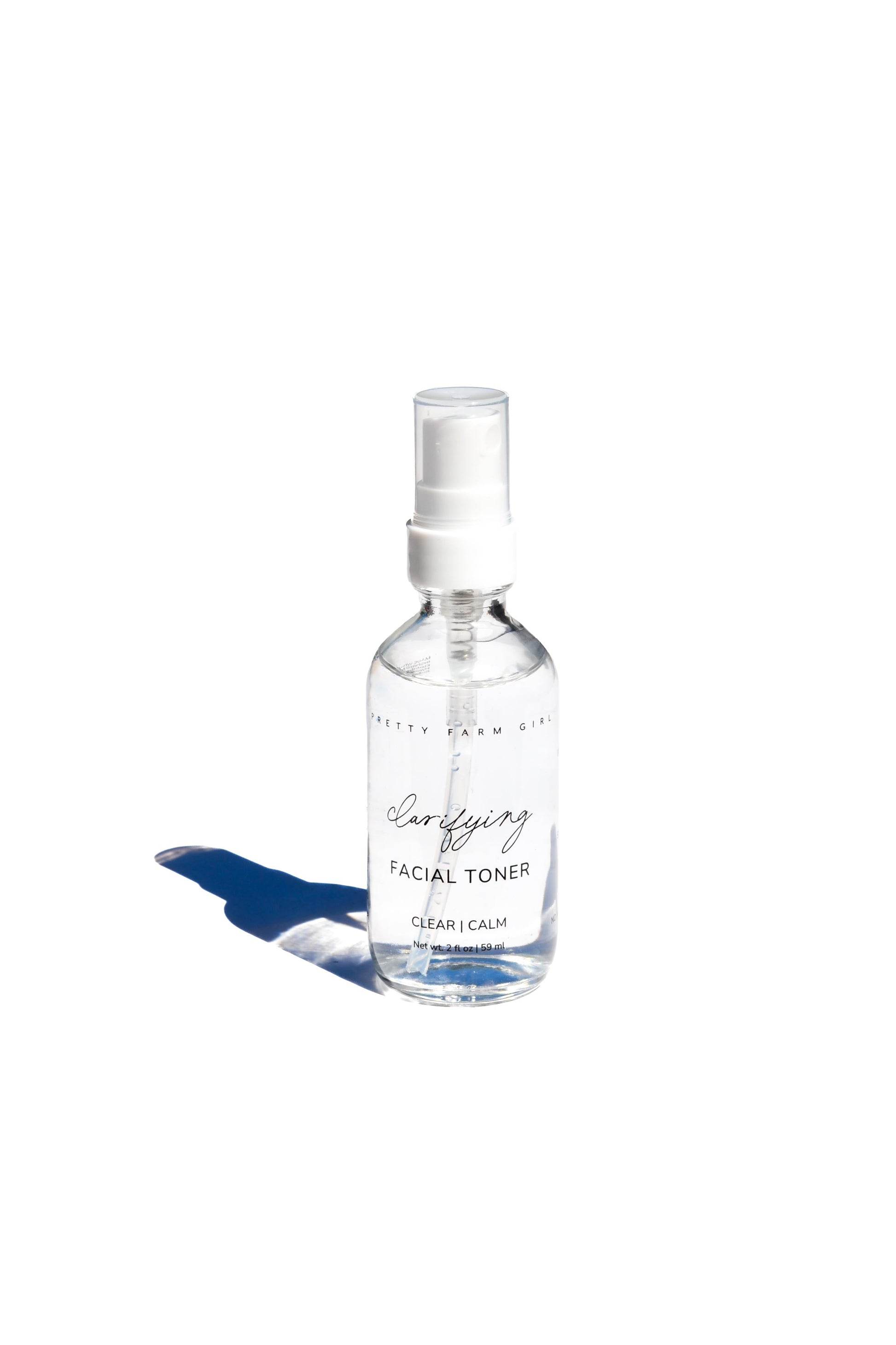 Pretty Farm Girl Clarifying Hypochlorous Acid Toner bottle, featuring clear liquid and minimalist packaging on a white background.