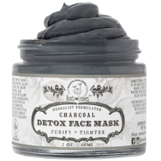 Charcoal detox face mask in a jar from Roots and Leaves LLC, showing the dark clay texture and packaging on a white background.