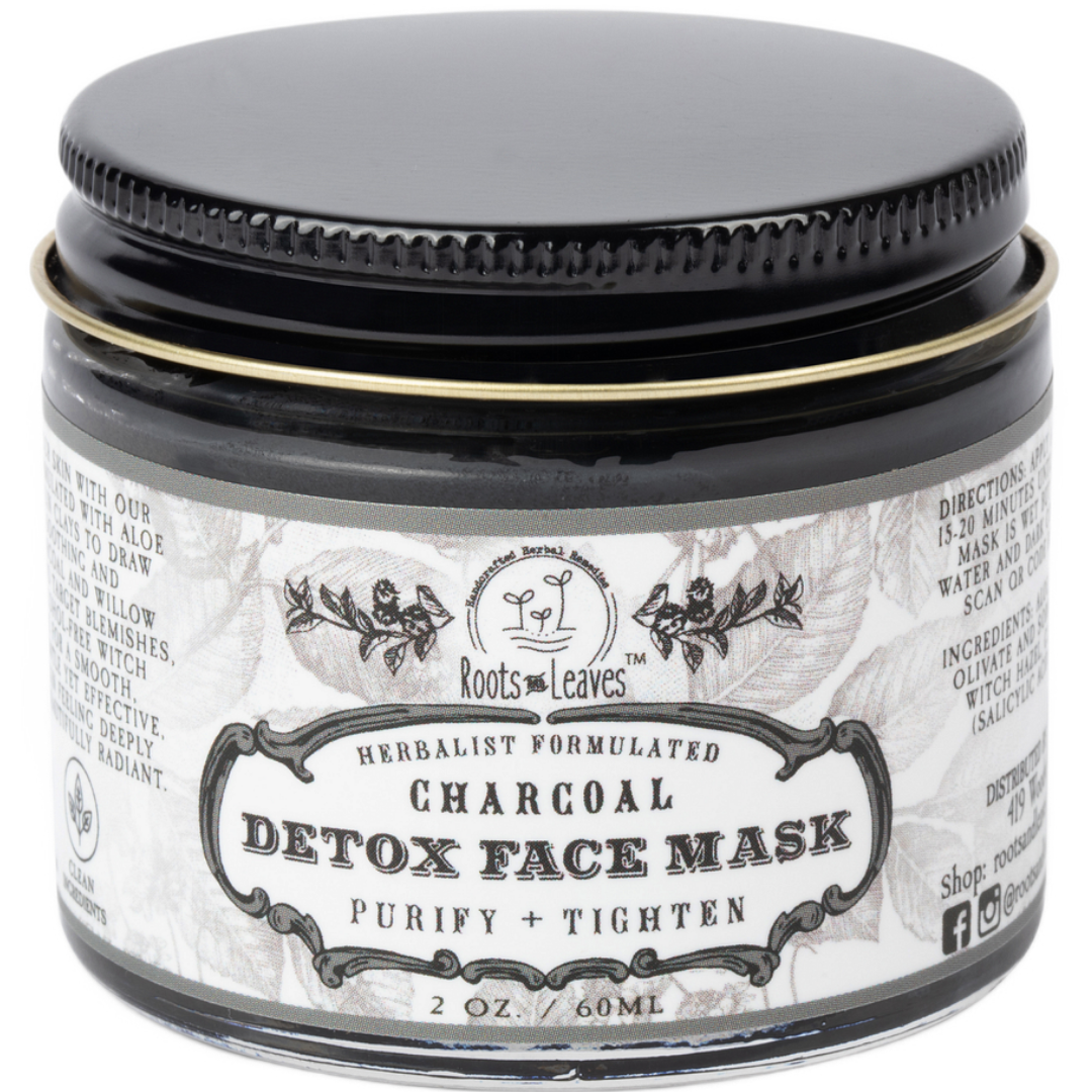 Charcoal Detox Face Mask by Roots and Leaves LLC shown in a jar with black clay and natural ingredients ready for skincare.