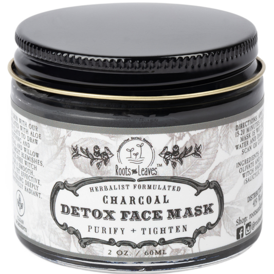 Charcoal Detox Face Mask by Roots and Leaves LLC shown in a jar with black clay and natural ingredients ready for skincare.