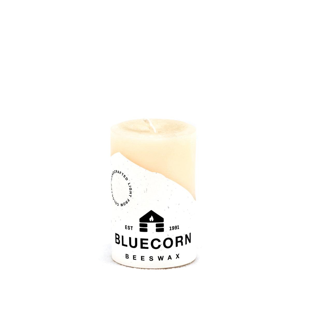Ivory Pure Beeswax Pillar Candles by Bluecorn Candles, showing tall, natural beeswax candles with textured surface and warm glow.