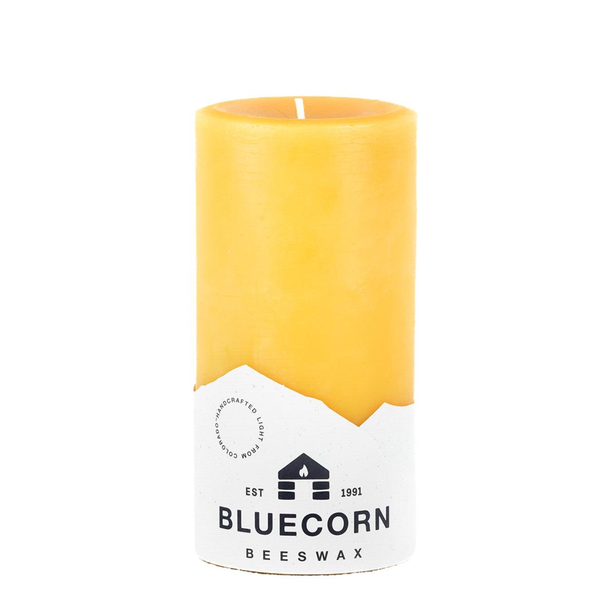 Pure beeswax pillar candles by Bluecorn Candles, showcasing natural yellow wax, tall cylindrical shape, and smooth finish.