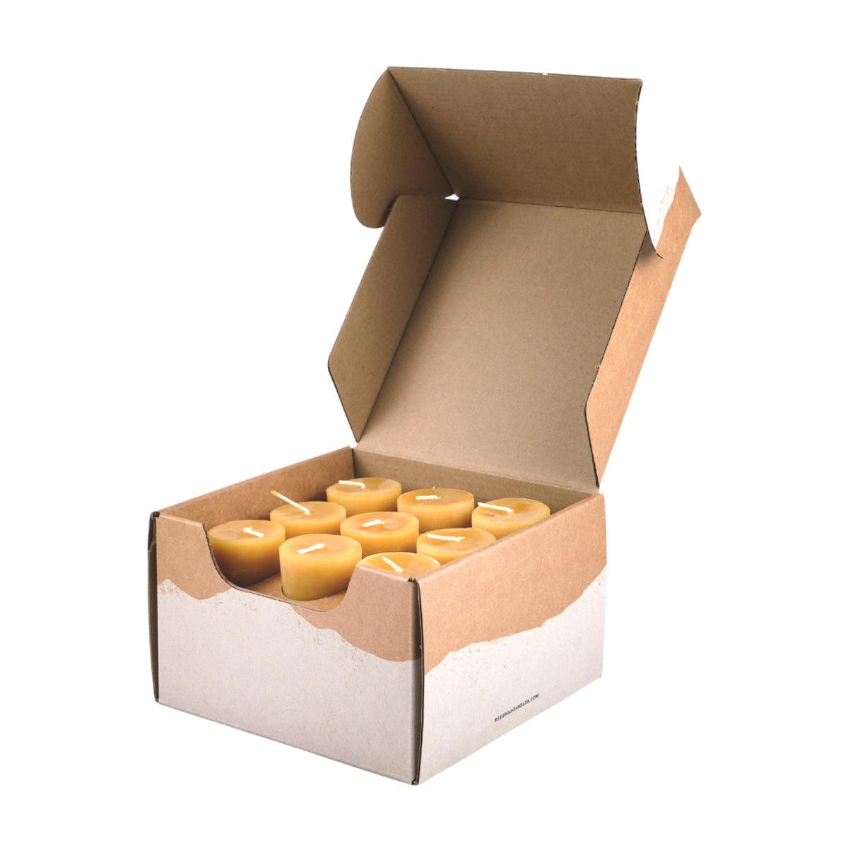 Set of three Bluecorn Candles pure beeswax votive candles with natural golden color and wicks, arranged on a white surface.