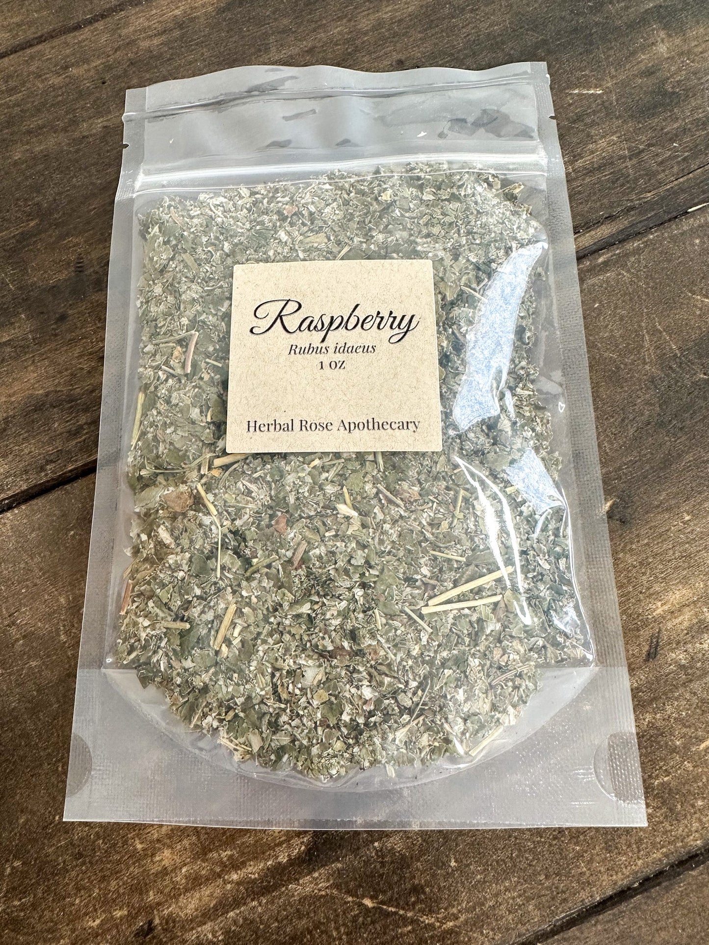 Dried raspberry leaf herb in a 1oz package from Herbal Rose Apothecary, showing the textured, dried raspberry leaves.