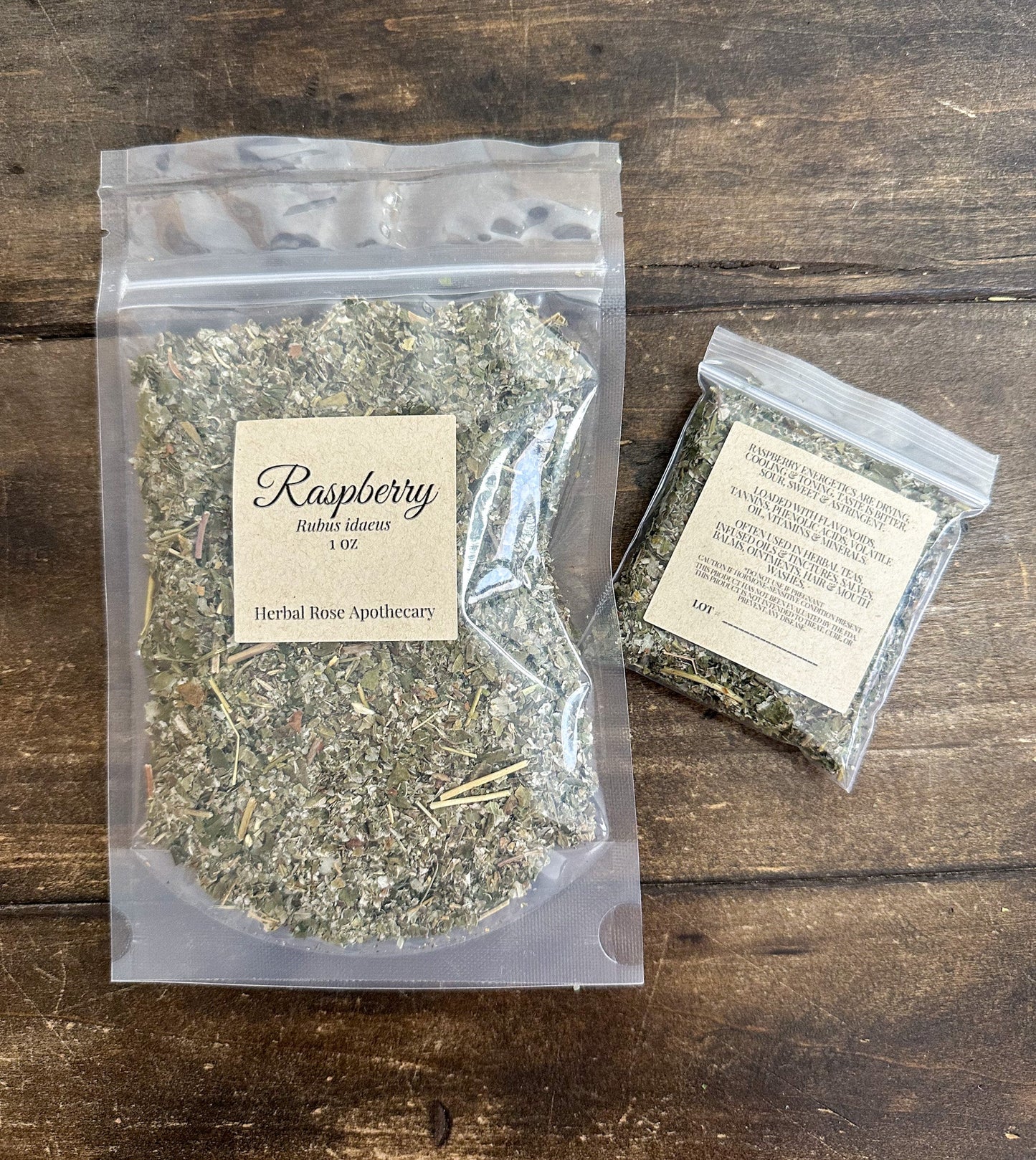 Dried raspberry leaf herbs in a clear glass jar, showing green leaves and stems, from herbalroseapothecary for herbal tea and remedies.