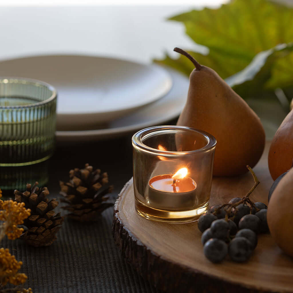 Raw beeswax tea light candle from Bluecorn Candles, showing natural textured beeswax surface and compact cylindrical shape.