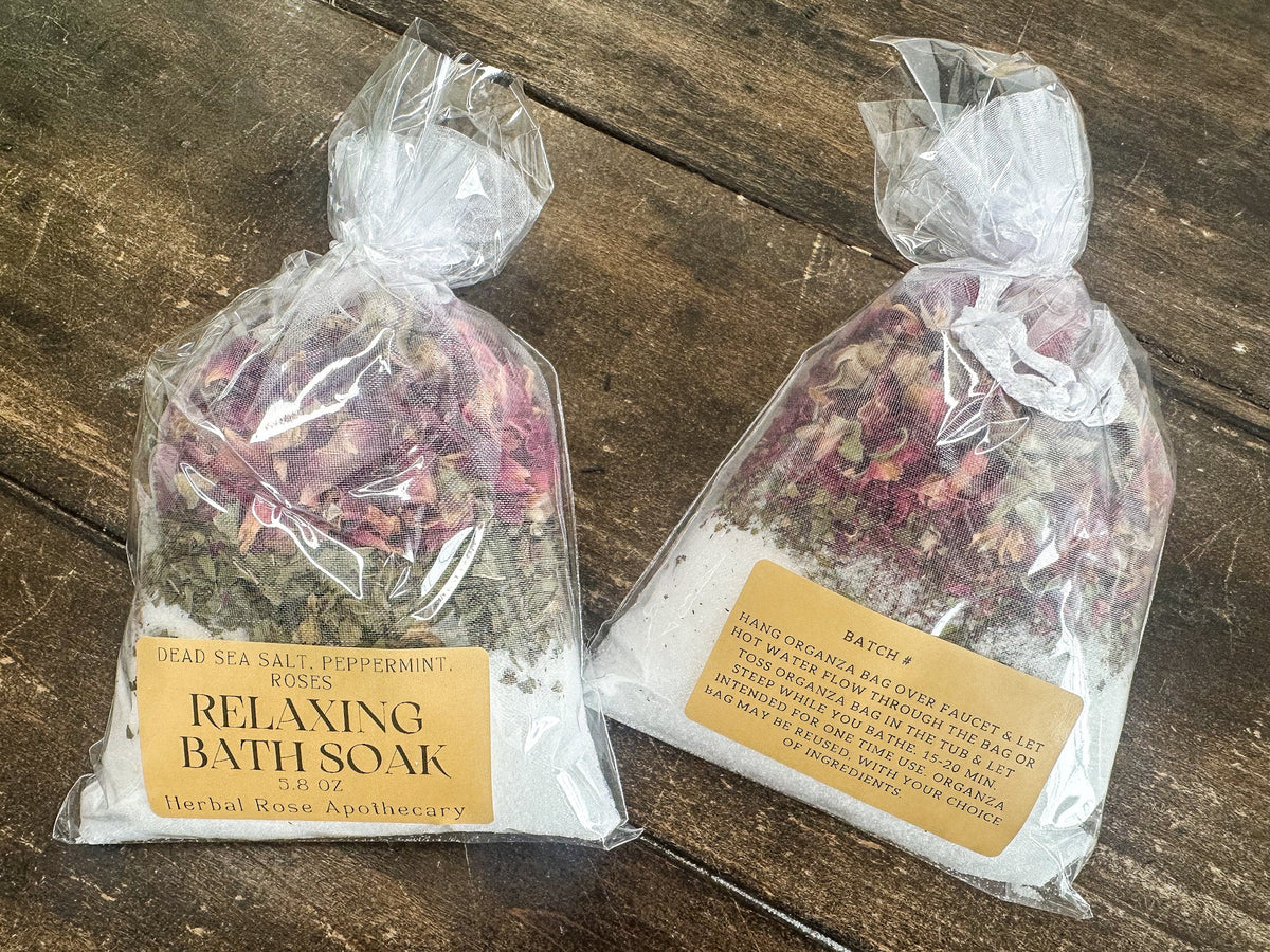Herbalroseapothecary relaxing herbal bath soak with dried herbs and botanicals in a glass jar, ideal for soothing baths.