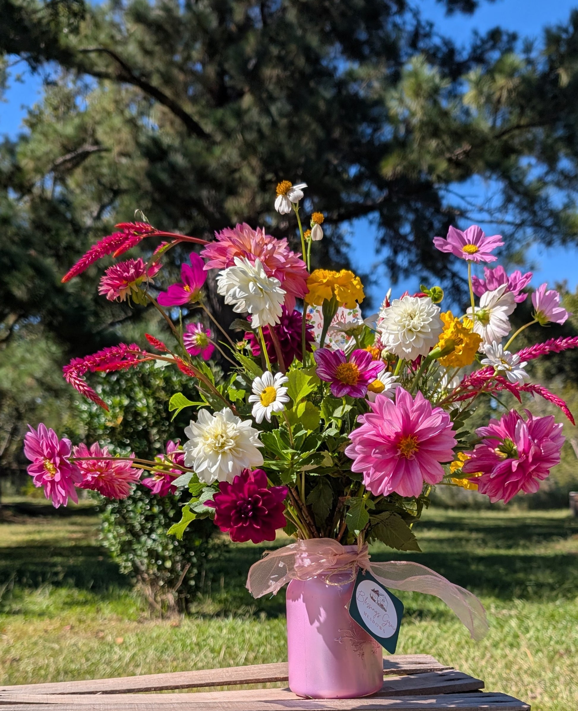 Fresh-cut flowers in a custom deluxe arrangement featuring colorful blooms from Blessings Grow Meadows Merch & More.