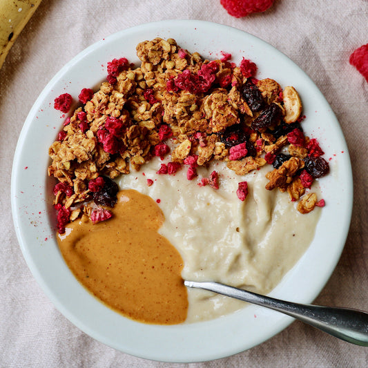 Canned Peanut Butter Crunch Granola by Rooted Living in a metal can with a label showing crunchy granola with peanut butter flavor.
