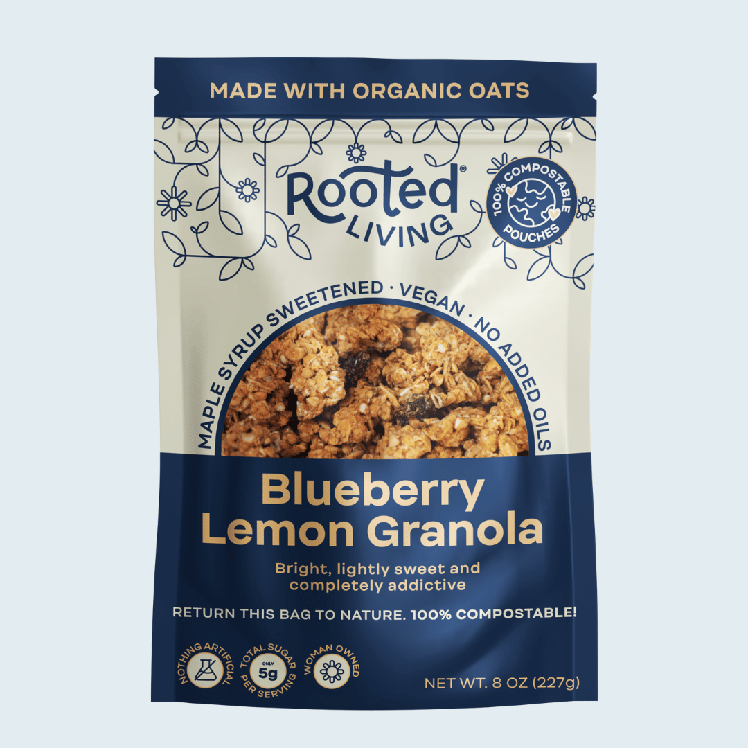 Crunchy blueberry lemon granola from Rooted Living displayed in a bowl with fresh blueberries and lemon slices.