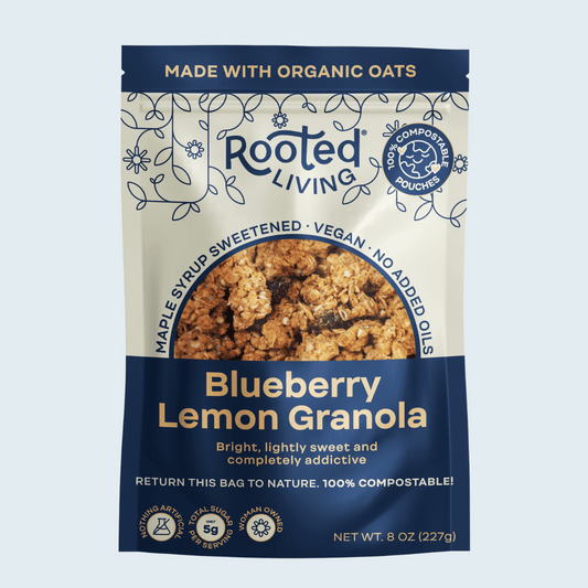 Crunchy blueberry lemon granola from Rooted Living displayed in a bowl with fresh blueberries and lemon slices.