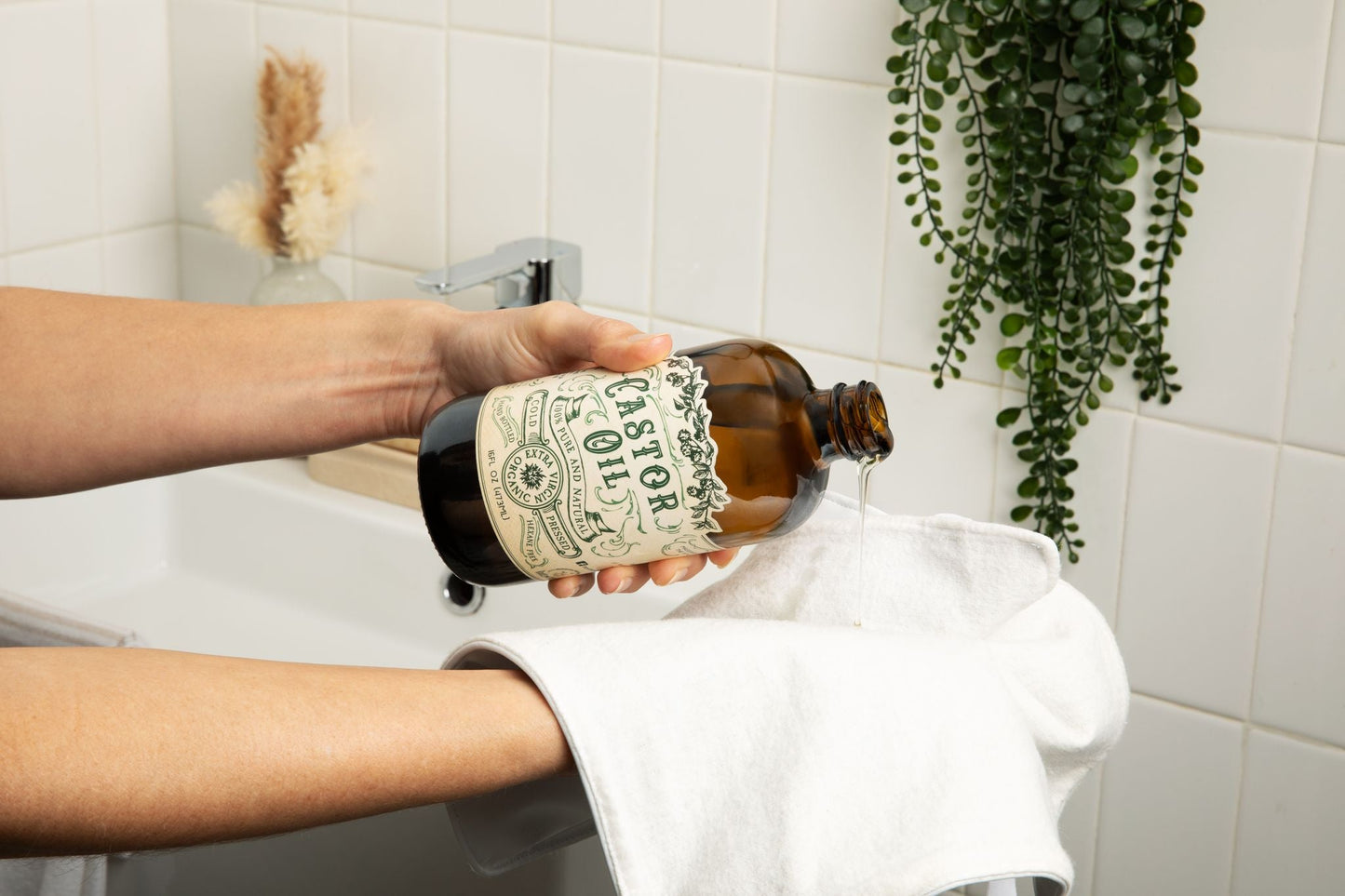 Organic cold pressed hexane-free castor oil in a 16 oz bottle from Roots and Leaves LLC, showing the clear oil inside the container.