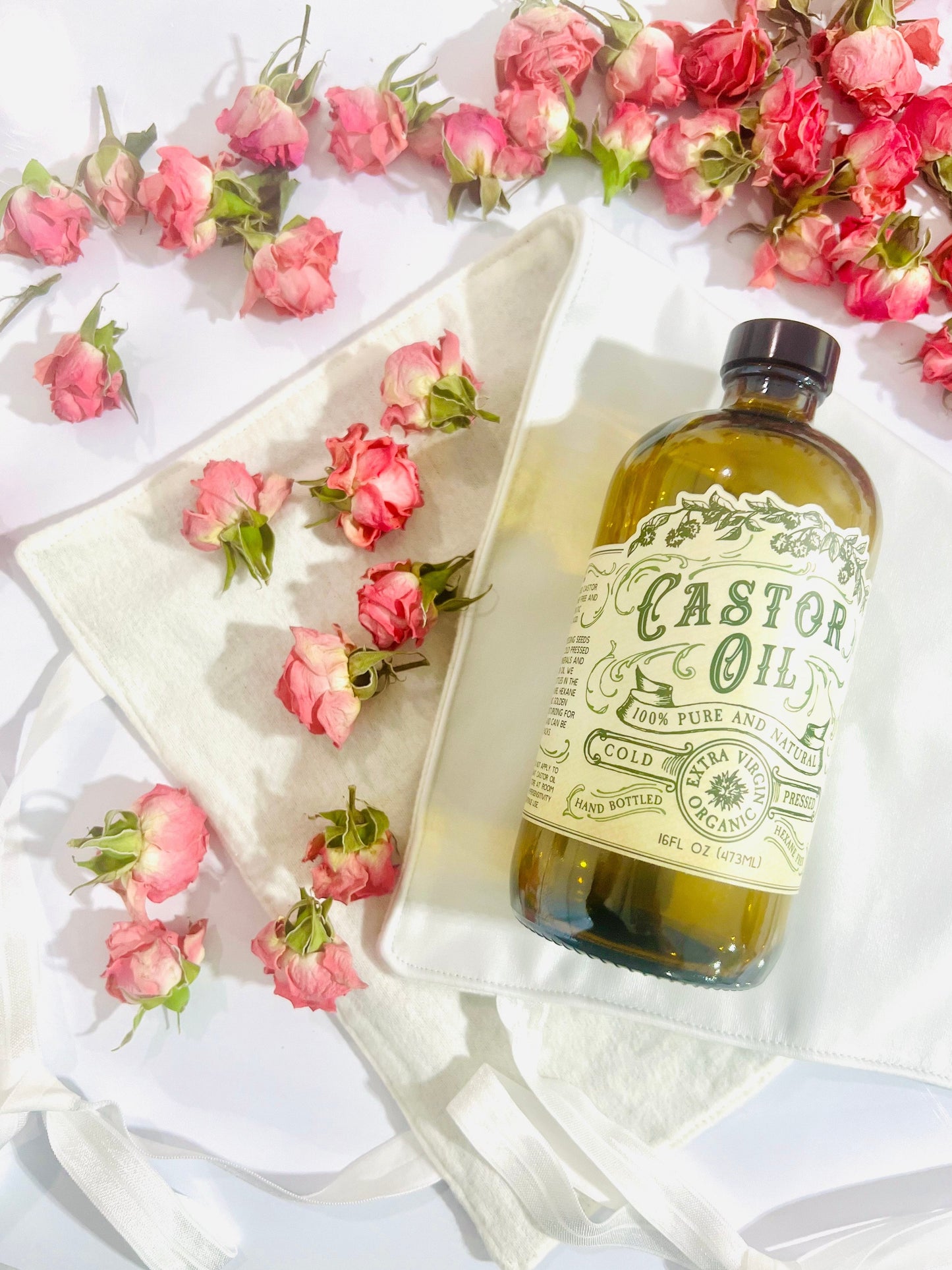 Organic cold pressed hexane-free castor oil from Roots and Leaves LLC in a 16 oz bottle, showing clear, golden oil inside.