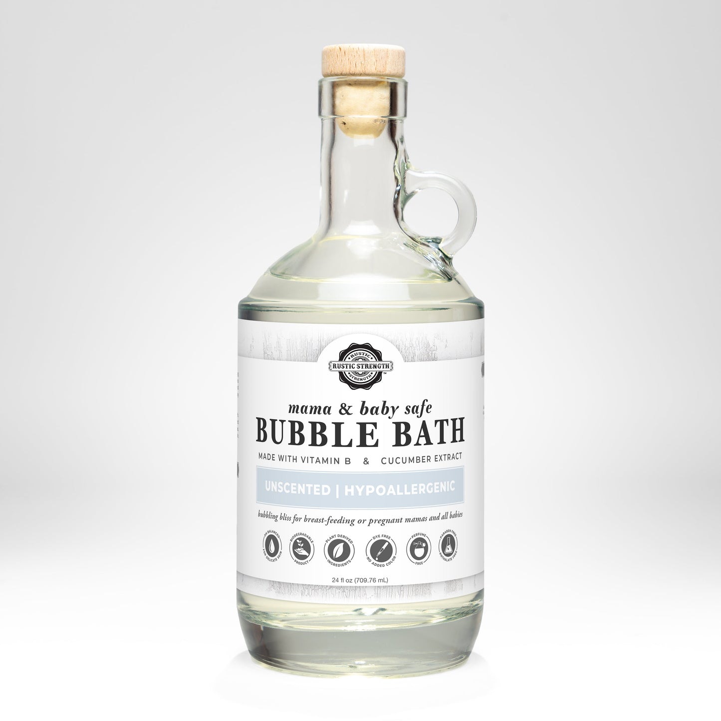 Clear glass bottle with wooden cork labeled Bubble Bath | Mama + Baby Safe by Rustic Strength. This hypoallergenic, unscented formula with vitamin E, cucumber extract, and Vitamin B Complex is gentle for all. Size: 24 fl oz.
