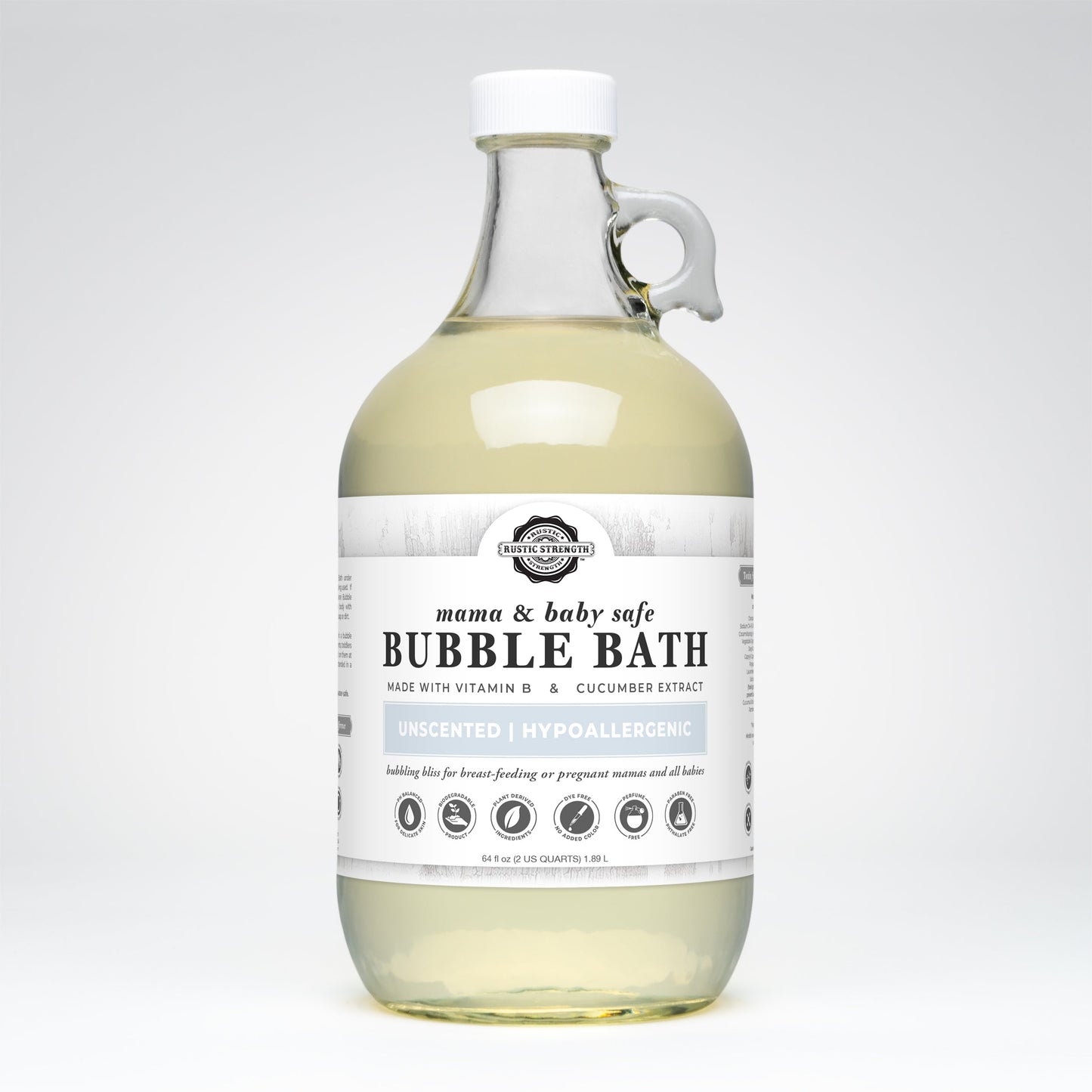 A clear bottle with a handle contains pale yellow liquid, labeled Rustic Strength Bubble Bath | Mama + Baby Safe. The unscented, hypoallergenic formula features vitamin E and cucumber extract.