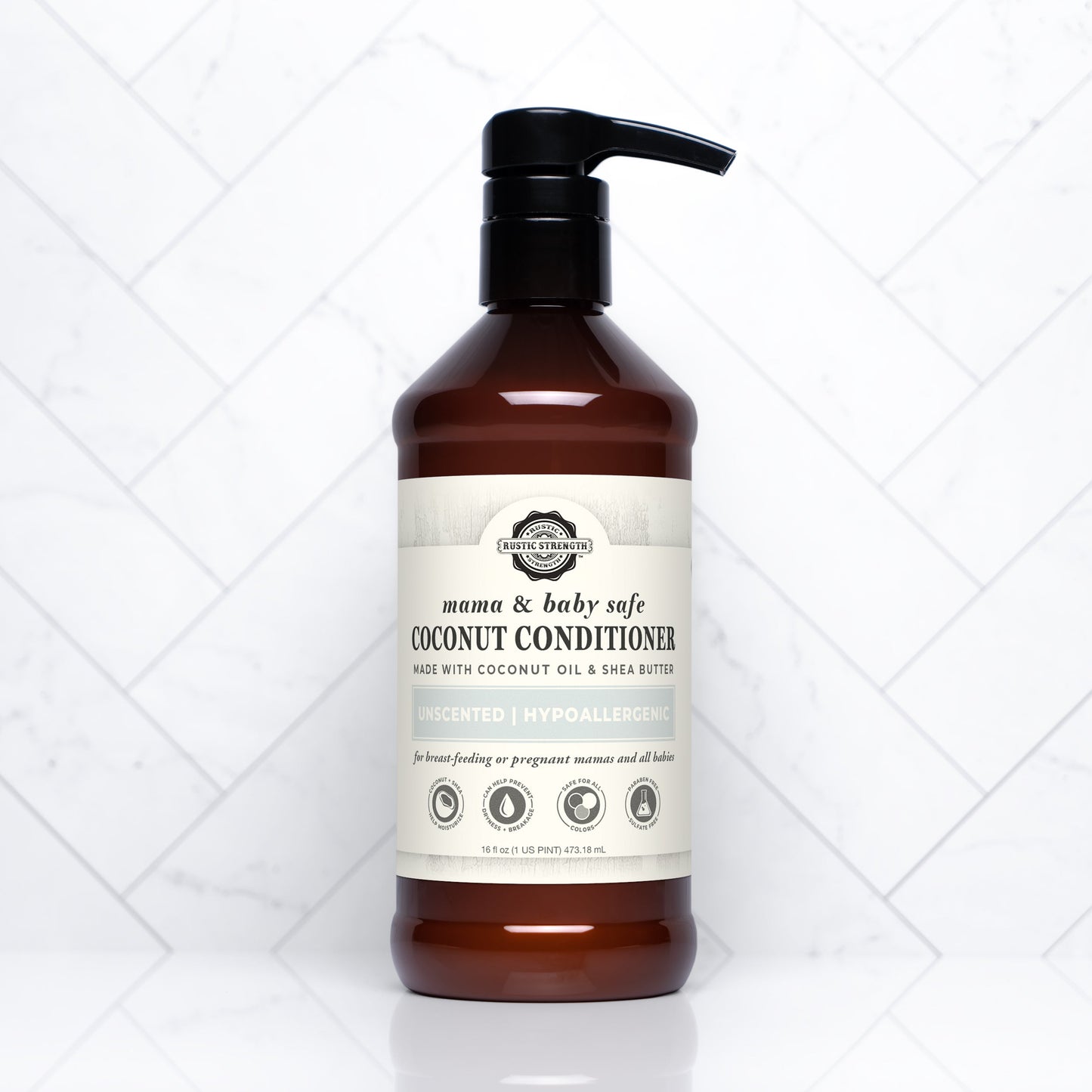 A brown plastic pump bottle of Rustic Strengths Coconut Conditioner | Mama + Baby Safe with a beige label, shown on a white tile background. The label notes it is unscented, hypoallergenic, and contains shea butter.