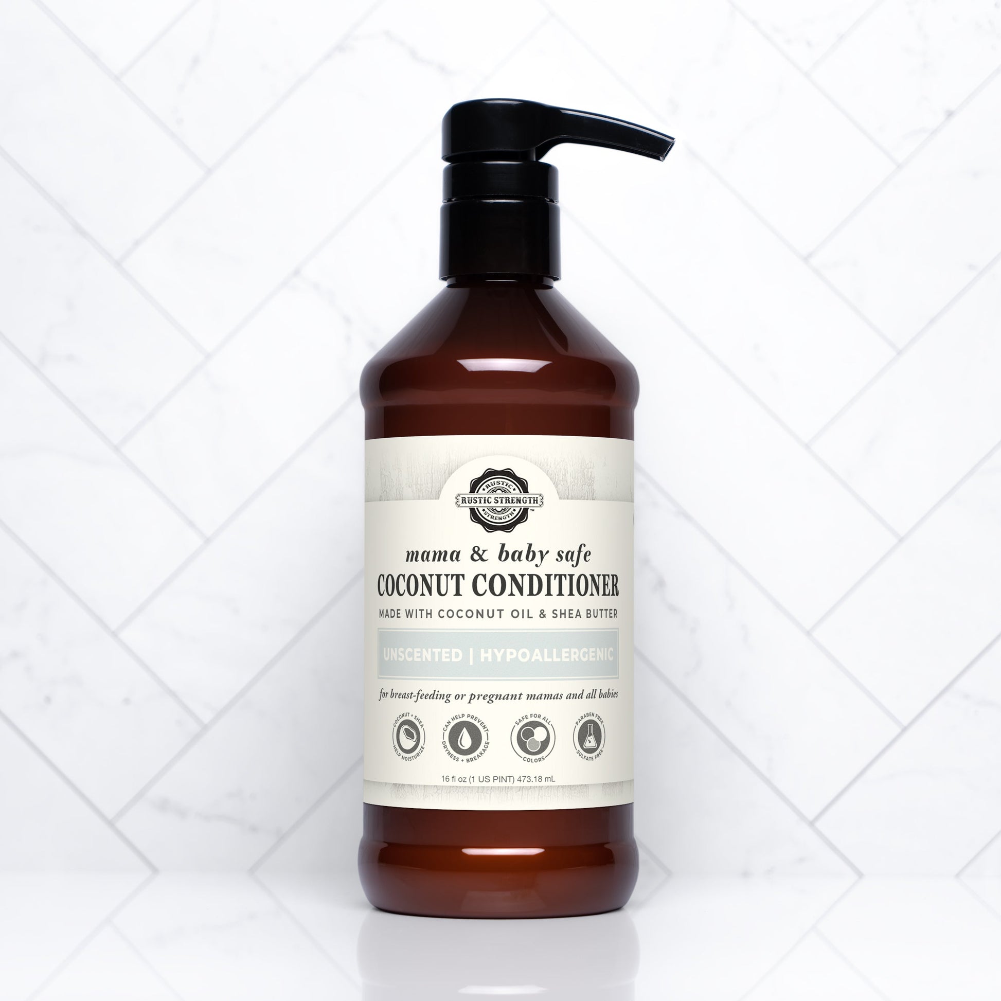 A brown plastic pump bottle of Rustic Strengths Coconut Conditioner | Mama + Baby Safe with a beige label, shown on a white tile background. The label notes it is unscented, hypoallergenic, and contains shea butter.