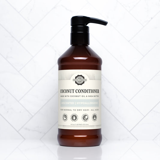 Rustic Strength unscented coconut conditioner in a 16 oz bottle, showing the conditioner's smooth, creamy texture and natural packaging.