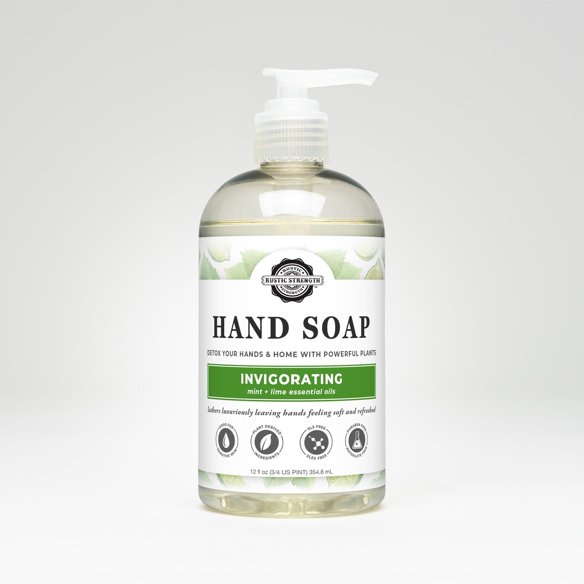 A clear plastic pump bottle of Rustic Strength Hand Soap | Invigorating, featuring a white label. Biodegradable and infused with peppermint lime essential oil, it claims to detox hands and home using plant-based ingredients.