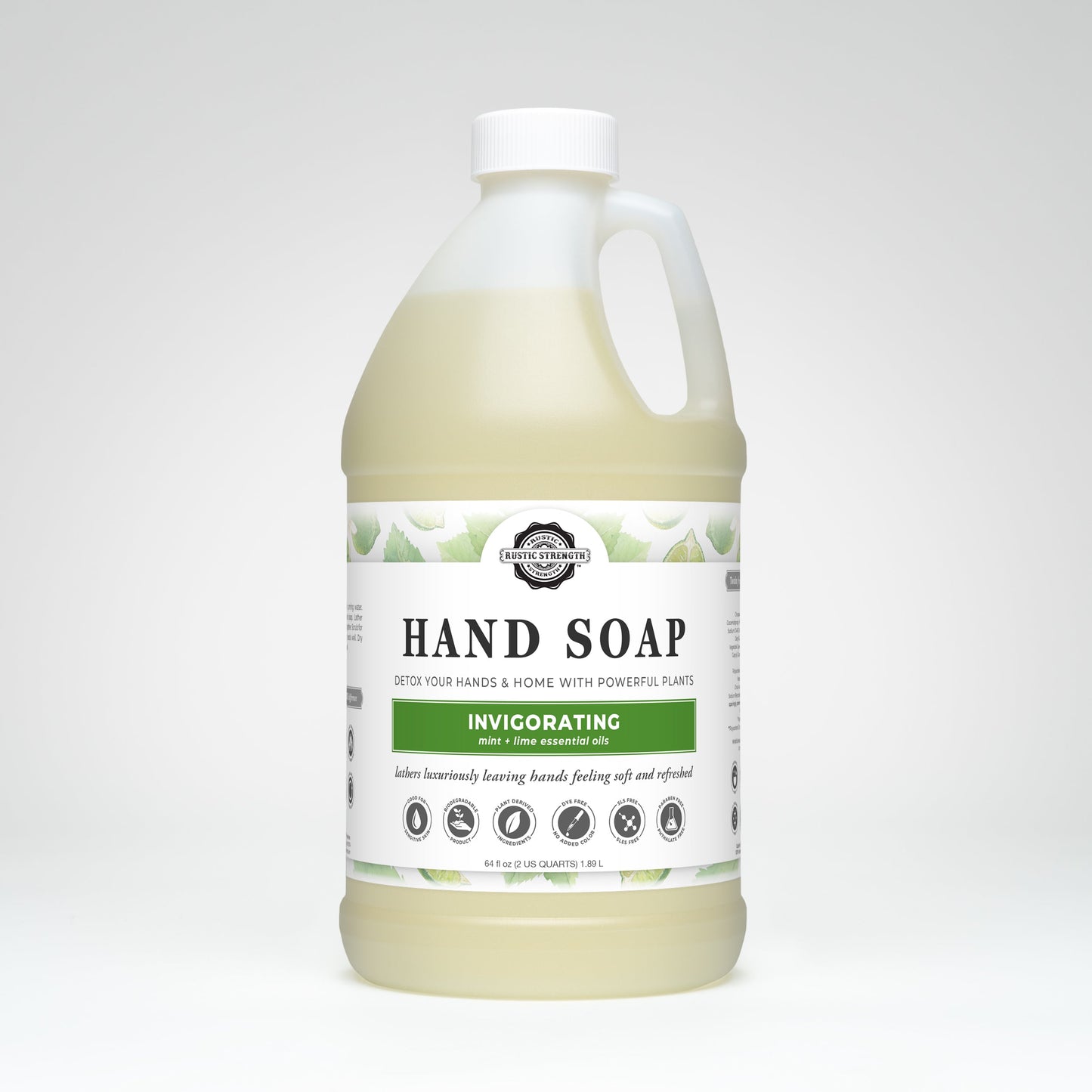 A large, clear plastic jug of Rustic Strength Hand Soap | Invigorating with biodegradable liquid and peppermint lime essential oil. The white label features green leaf designs, product icons, and brand details.