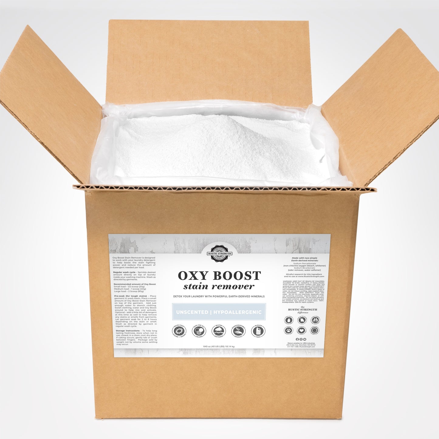 An open box of Rustic Strength Oxy Boost Stain Remover shows white powder and a label with product info and icons for toxin-free, color-safe, unscented, hypoallergenic, and eco-friendly features.