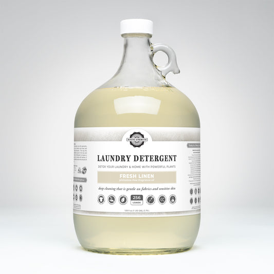 A clear gallon jug of Rustic Strength Laundry Detergent | Fresh Linen with a white label and cap, featuring 256 loads text, is shown against a plain white background.