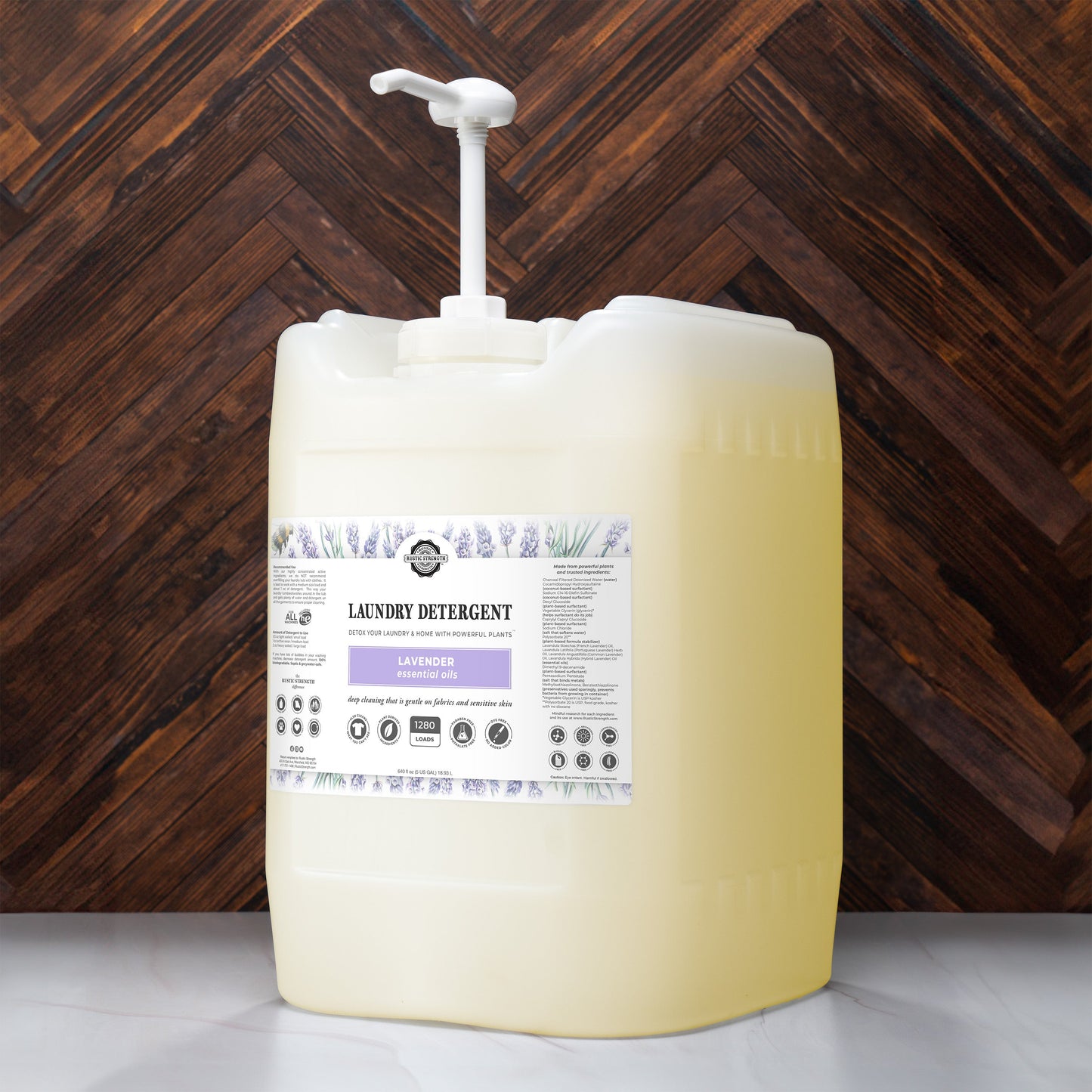 Rustic Strength lavender laundry detergent in a 24 oz glass bottle, showcasing the product with lavender scent and clean design.