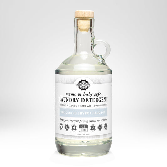 A clear glass bottle with handle contains Rustic Strength Laundry Detergent | Mama + Baby Safe for sensitive skin, unscented, 48 loads, shown against a plain white background.
