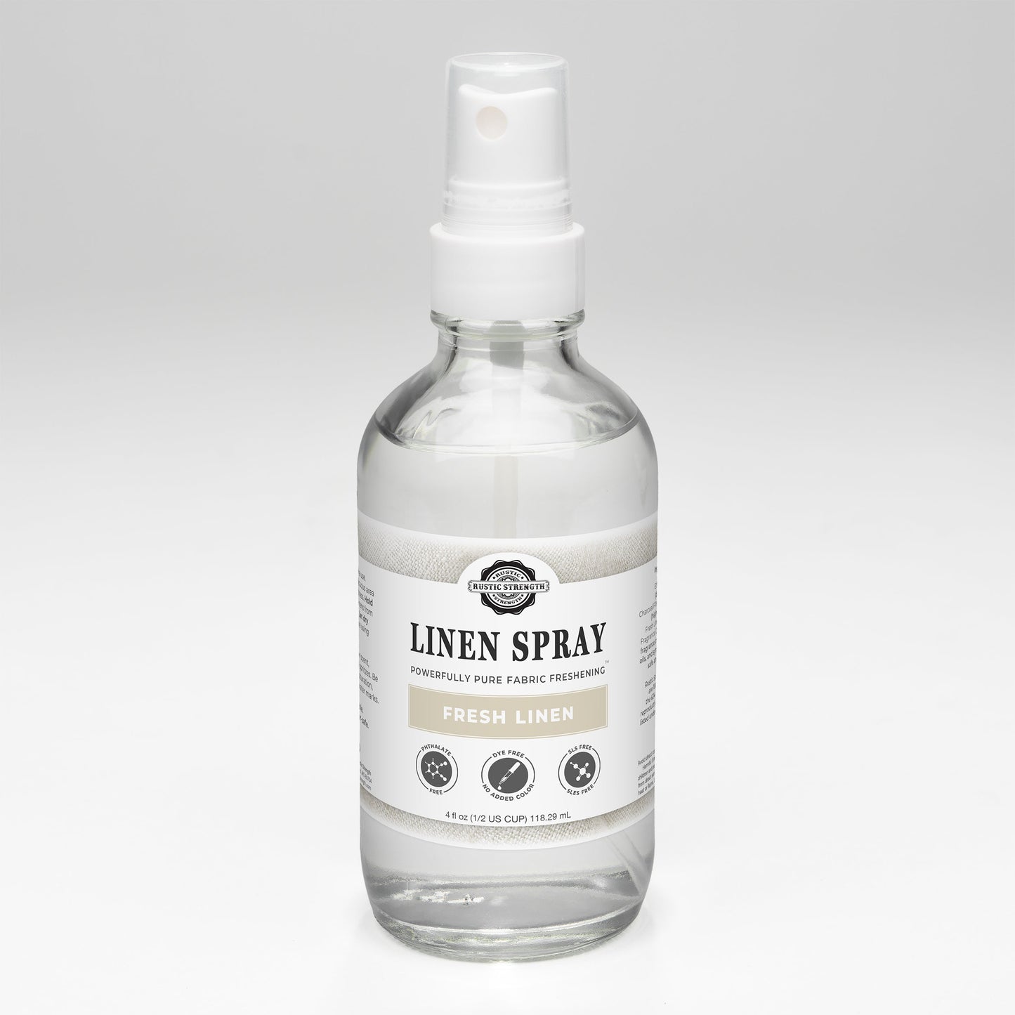 Rustic Strength Fresh Linen Spray featuring a clear glass bottle with a white spray nozzle and a minimalist label.