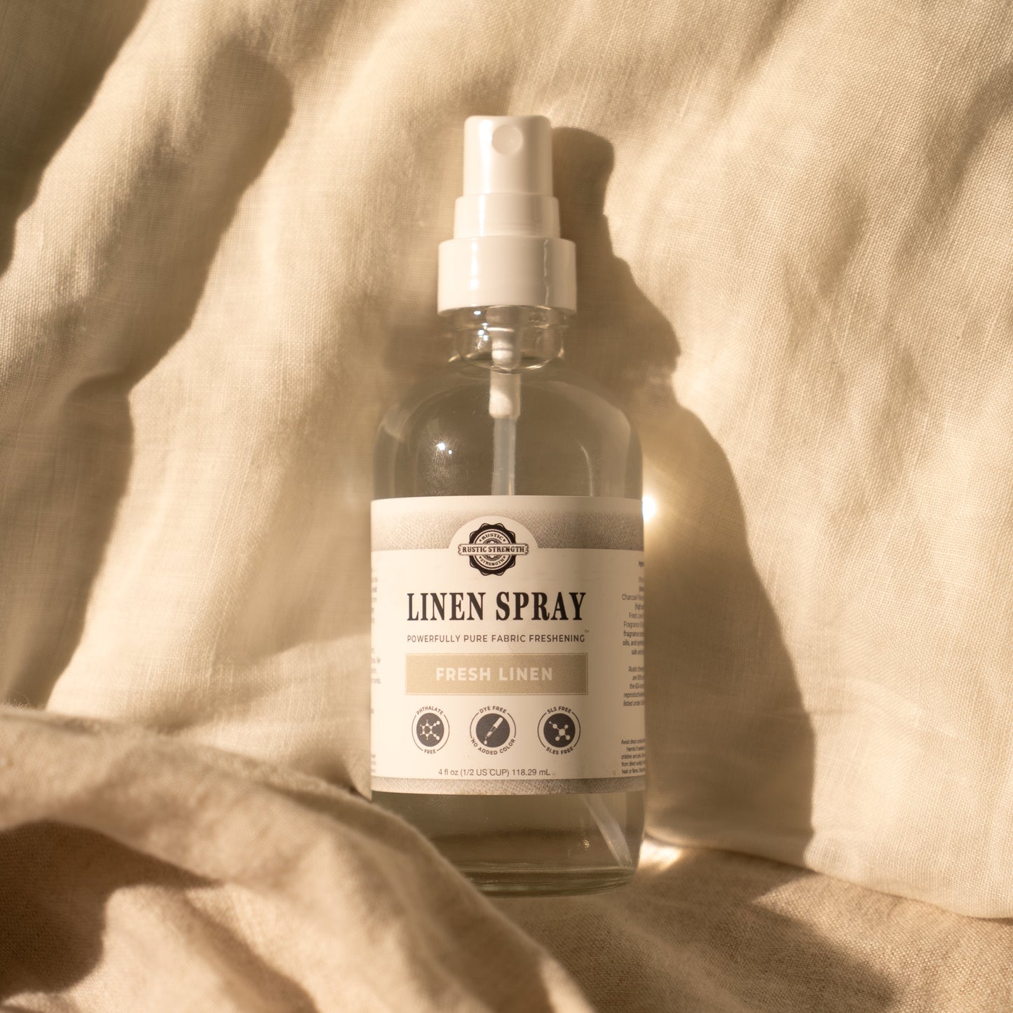 Rustic Strength Fresh Linen Linen Spray bottle with a clean, minimalist design, perfect for freshening up linens and fabrics.