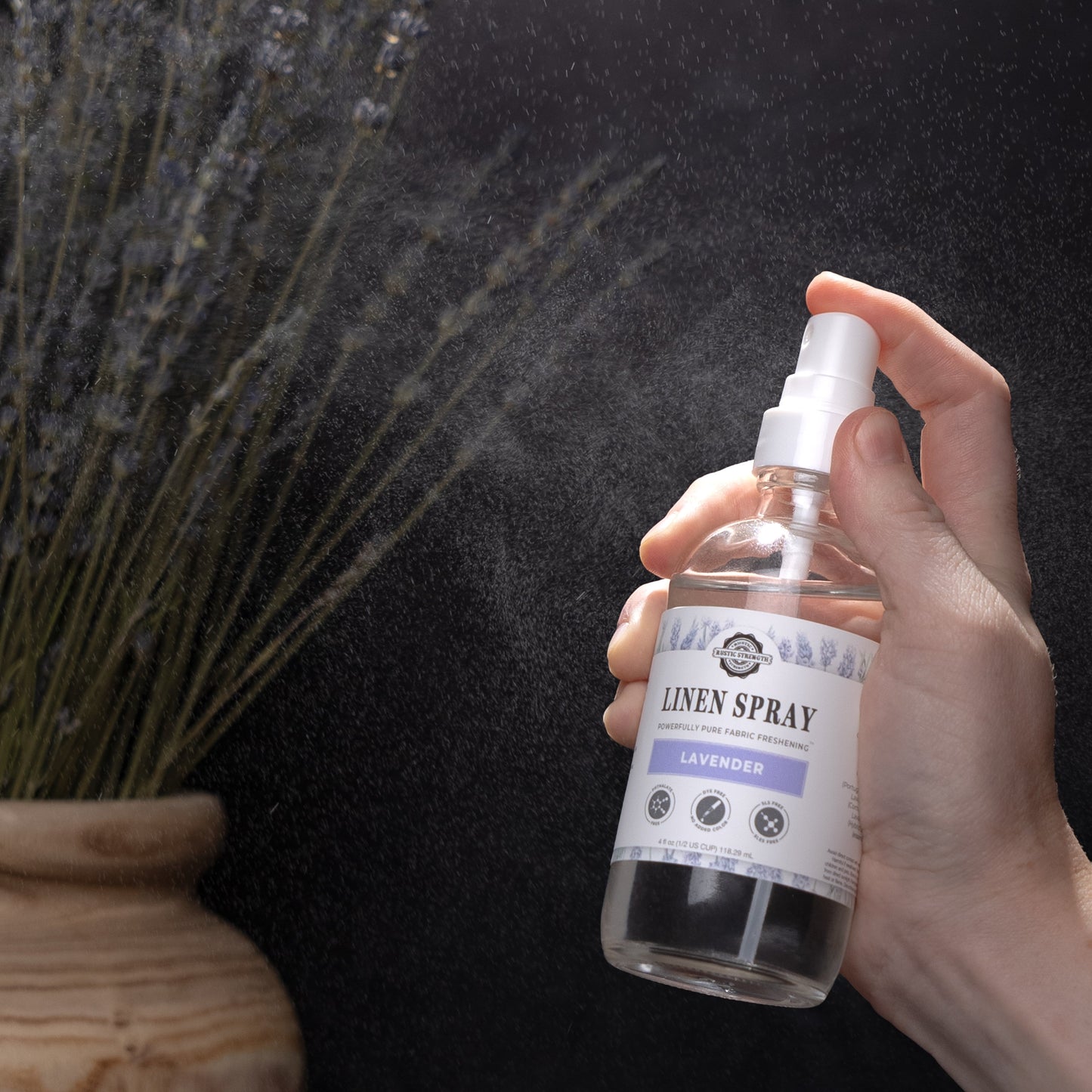 Rustic Strength Fresh Linen Linen Spray bottle with a clear label, featuring a simple design and white spray nozzle.