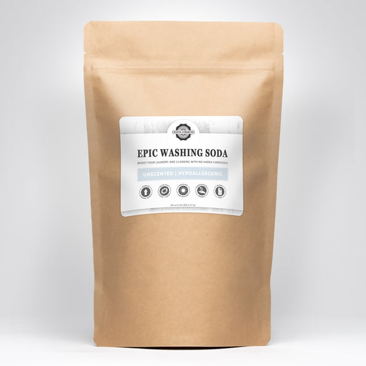 An upright brown resealable bag labeled Rustic Strength Epic Washing Soda, an unscented, hypoallergenic, eco-friendly cleaner, is shown against a plain white background.